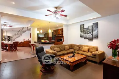 Spacious open-plan living room with modern decor and stylish kitchen area.