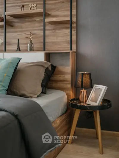 Cozy bedroom with stylish wooden headboard and elegant bedside lamp