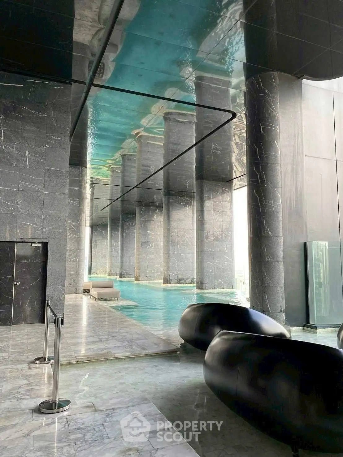 Luxurious indoor pool with sleek modern design and marble accents