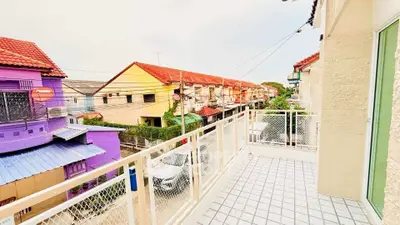 Charming balcony with vibrant neighborhood view and colorful houses