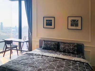 Modern bedroom with city view, stylish decor, and natural light.
