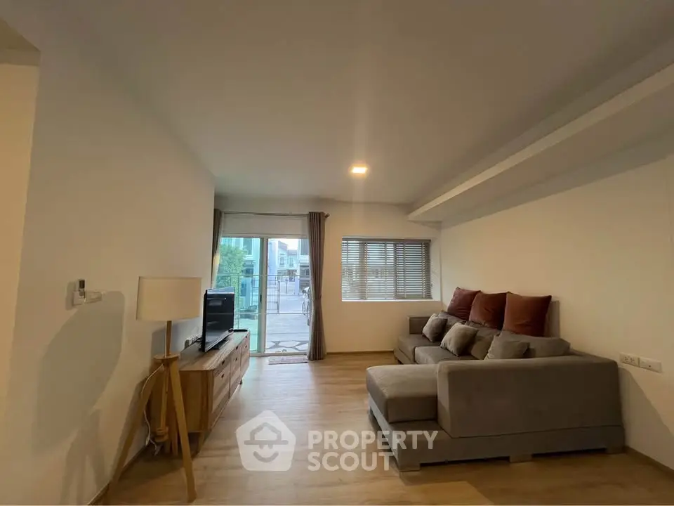 Spacious living room with modern decor and large windows for natural light.