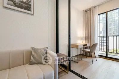 Modern living room with study area and balcony view in a stylish apartment.