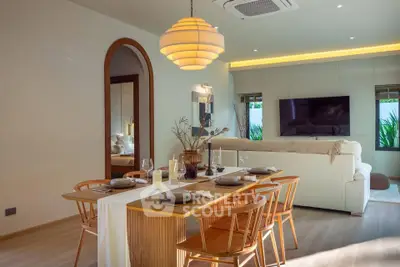 Elegant living room with modern dining area, stylish lighting, and cozy seating, perfect for entertaining guests.