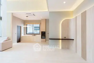 Spacious modern living room with open kitchen and elegant lighting