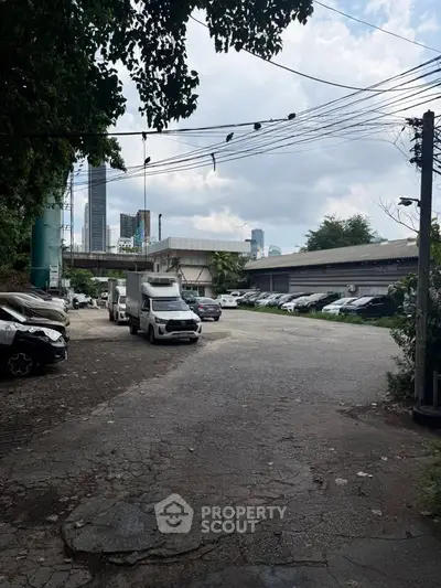 Spacious urban parking area with city skyline view, ideal for commercial use or development opportunities.
