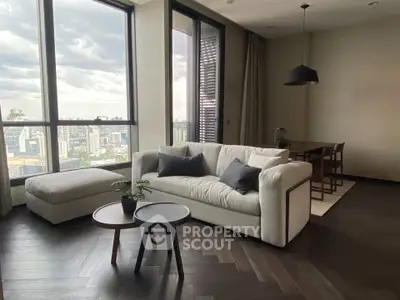 Luxurious living room with stunning city view, featuring modern furniture and elegant decor.