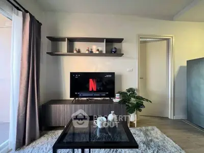 Modern living room with stylish decor and entertainment setup, featuring a sleek TV stand and cozy ambiance.