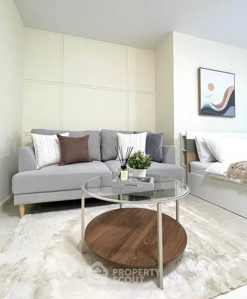 Modern living room with stylish sofa and coffee table in a cozy apartment setting.