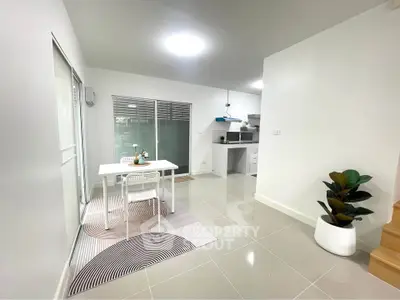 Modern open-plan dining area with sleek kitchen and stylish decor