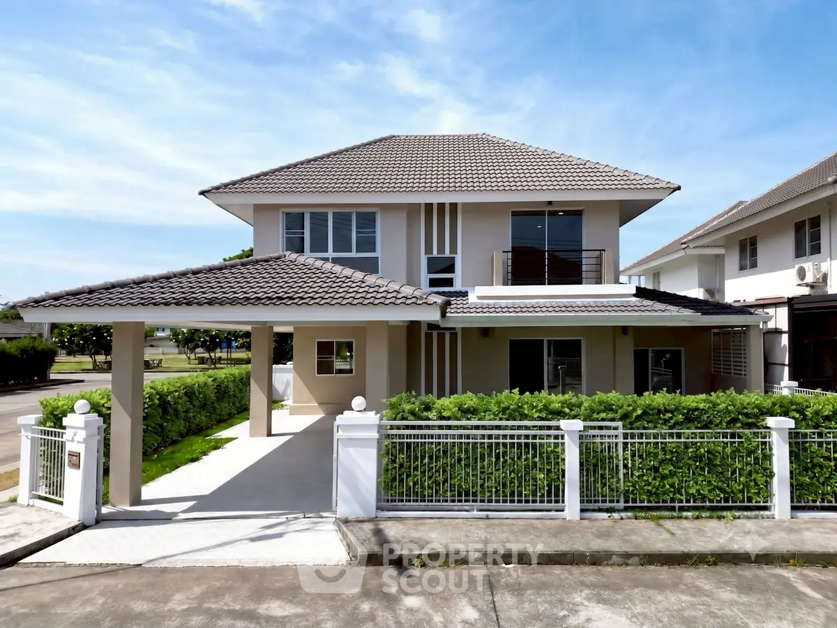 Stunning two-story modern house with lush greenery and spacious driveway in a serene neighborhood.