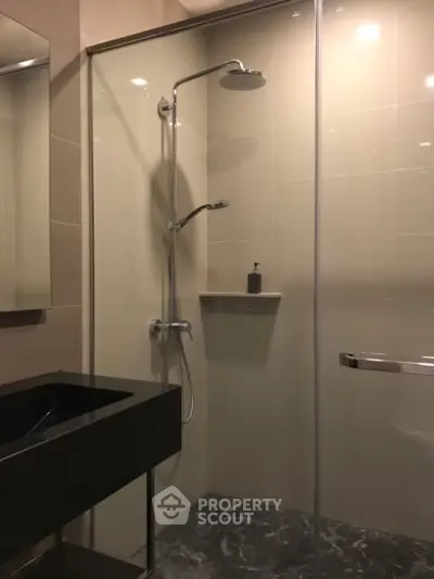 Modern bathroom with sleek shower and elegant black sink
