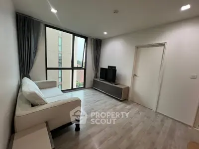 Modern living room with large window and stylish furniture