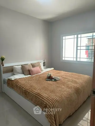 Cozy bedroom with large bed and soft lighting, perfect for relaxation and comfort.
