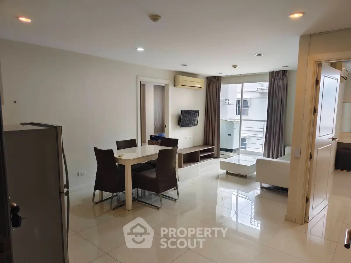 Spacious modern living room with dining area and balcony access