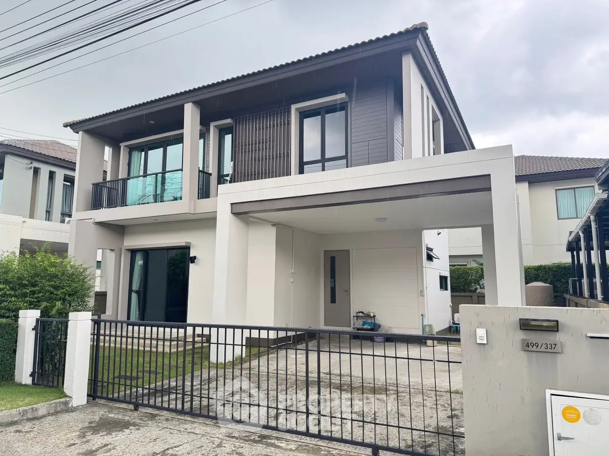 Modern two-story house with spacious driveway and sleek architectural design.