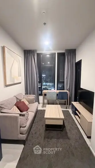 Modern living room with stylish furniture and large window view