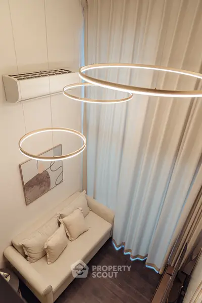 Modern living room with elegant lighting and cozy sofa, perfect for urban living.