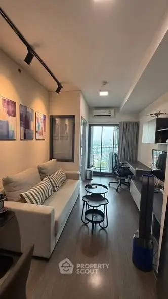 Modern living room with stylish decor and city view from balcony
