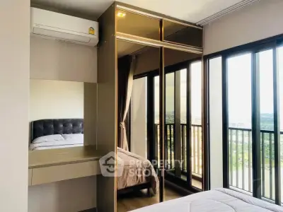 Modern bedroom with mirrored wardrobe and balcony view in high-rise apartment.