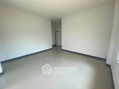 Spacious empty room with large windows and sleek tiled flooring, perfect for customization.