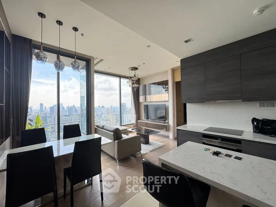 Luxurious modern living room with stunning city view and elegant kitchen design.