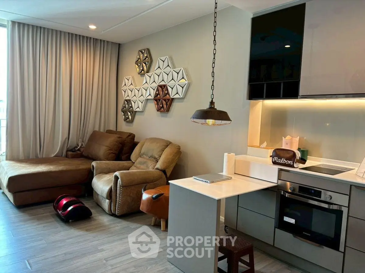 Modern living room with cozy seating and stylish kitchen area