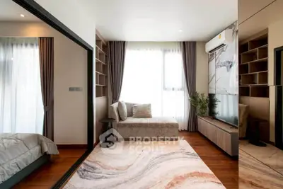 Modern living room with elegant decor, large window, and cozy seating area in a stylish apartment.