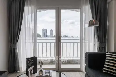 Stylish living room with balcony view and modern decor in urban apartment