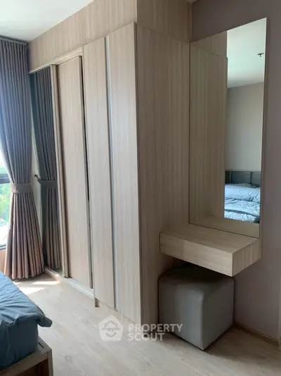 Modern bedroom with sleek wooden wardrobe and natural light