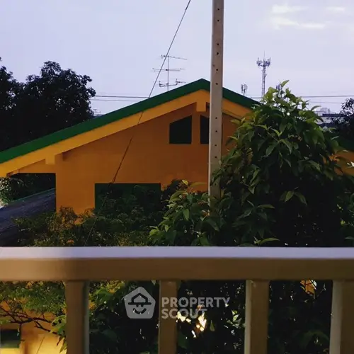 Charming suburban home with vibrant yellow facade and lush greenery