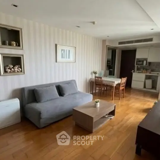 Spacious living room with modern decor and open kitchen layout in a stylish apartment.