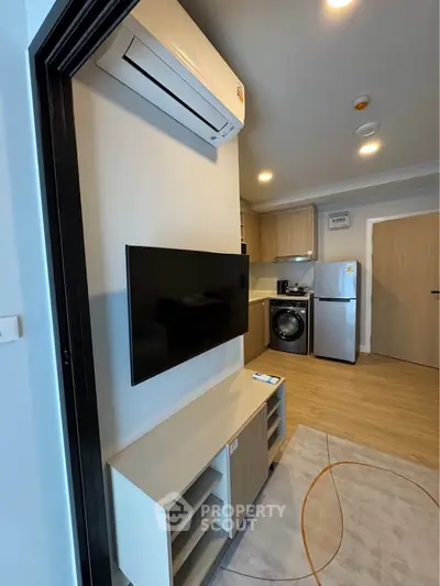 Modern living room with sleek kitchen and appliances in a stylish apartment