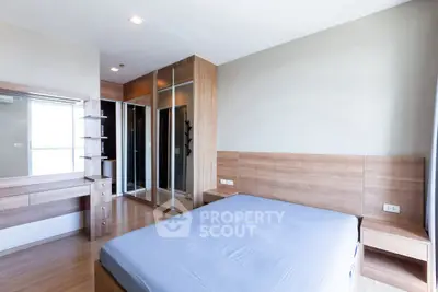 Modern bedroom with wooden furniture and large mirrored wardrobe