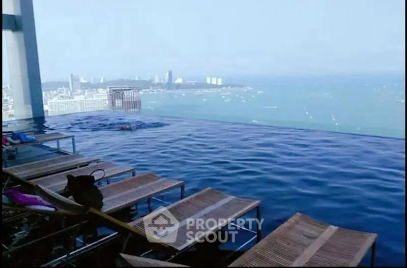 Stunning rooftop infinity pool with breathtaking ocean view and city skyline.