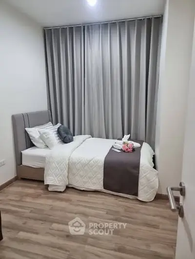 Cozy bedroom with elegant decor and soft lighting, featuring a comfortable bed and stylish curtains.