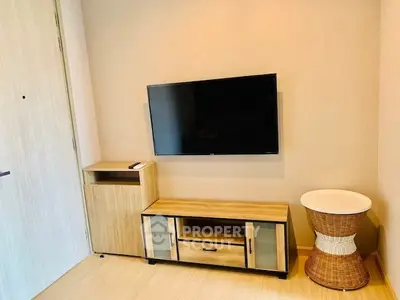 Modern living room with mounted TV and stylish wooden furniture