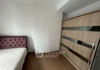 Cozy bedroom with modern wardrobe and stylish headboard, perfect for restful nights.