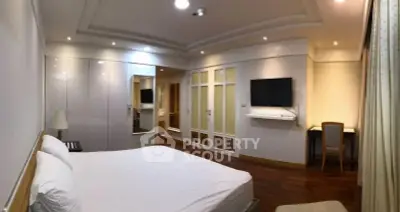 Spacious bedroom with modern design and ample storage in luxury apartment.