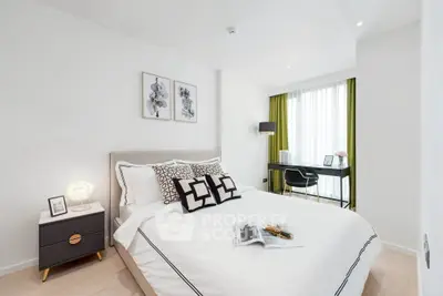 Modern bedroom with stylish decor and natural light, featuring a cozy bed and a functional study area.