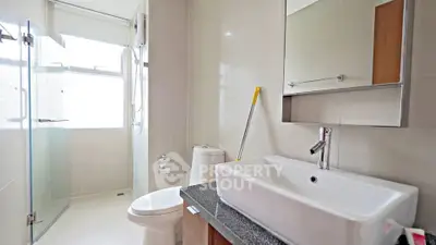 Modern bathroom with sleek fixtures and glass shower enclosure