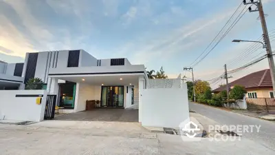 Modern white house exterior with spacious driveway and contemporary design