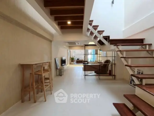 Spacious modern living room with open staircase and stylish decor