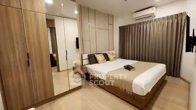 Modern bedroom with wooden accents and mirrored wardrobe, featuring cozy lighting and elegant decor.