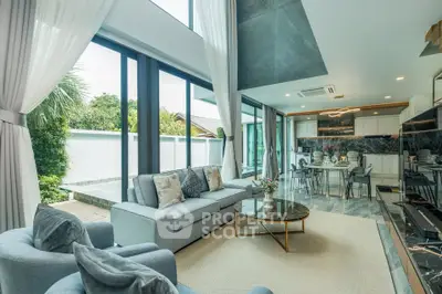 Luxurious open-plan living room with modern kitchen and large windows