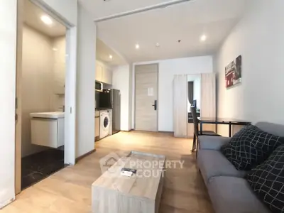 Modern apartment interior with open living area, stylish furniture, and in-unit laundry facilities.