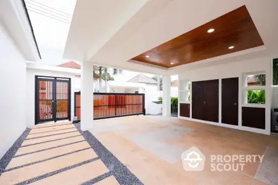 Modern covered parking area with stylish wooden gate and ceiling design