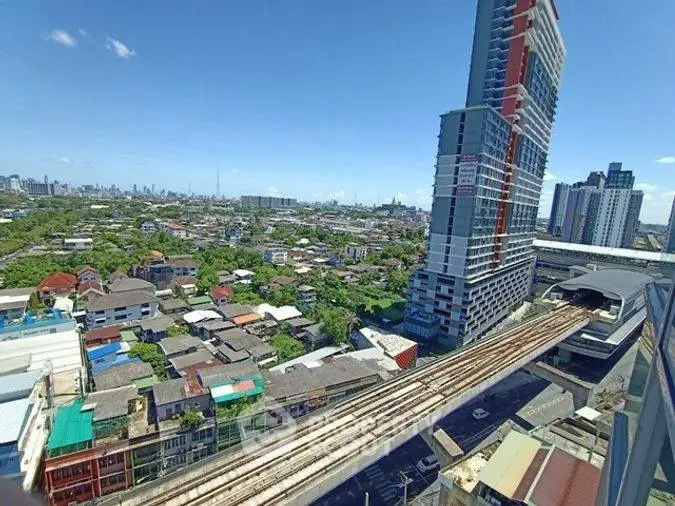 Stunning cityscape view from high-rise building near train tracks, showcasing urban living.