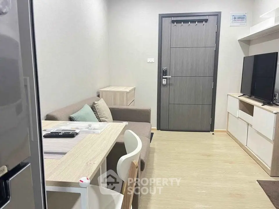 Cozy modern living room with sleek furniture and entertainment setup, perfect for urban living.