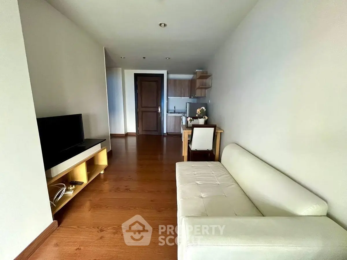 Modern living room with sleek furniture and open kitchen layout